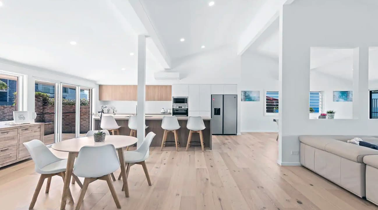 New entry and kitchen view, existing walls around the entry are removed making a spacious open plan